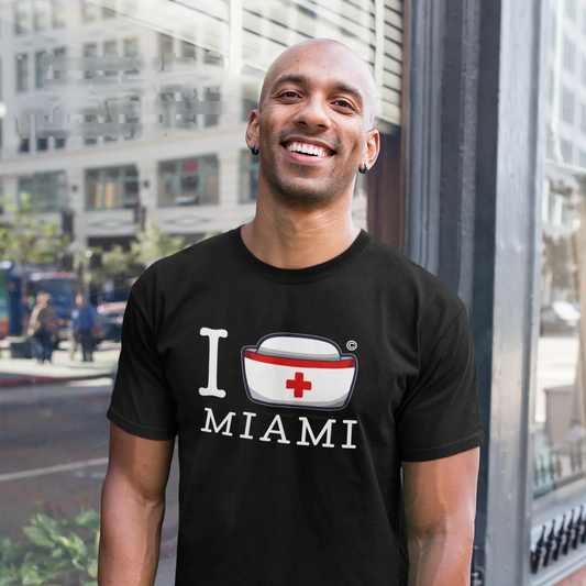 Nurse wearing the I Nurse Miami black t-shirt on a city street